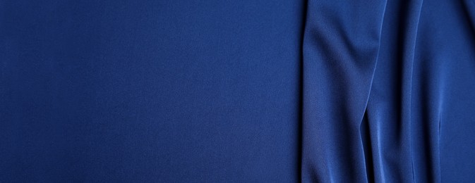 Image of Dark blue silk fabric as background, top view with space for text. Banner design