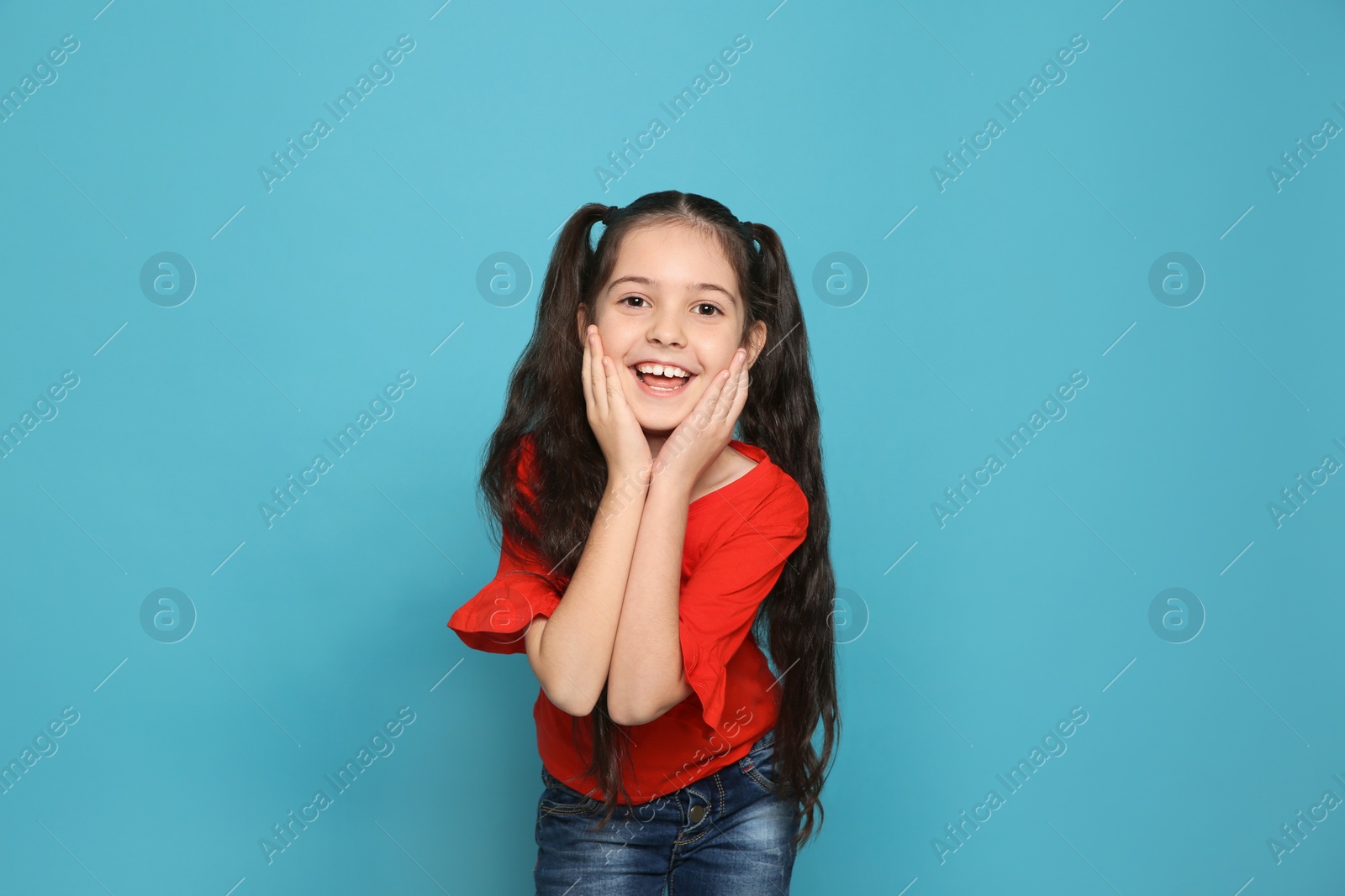 Photo of Portrait of little girl laughing on color background