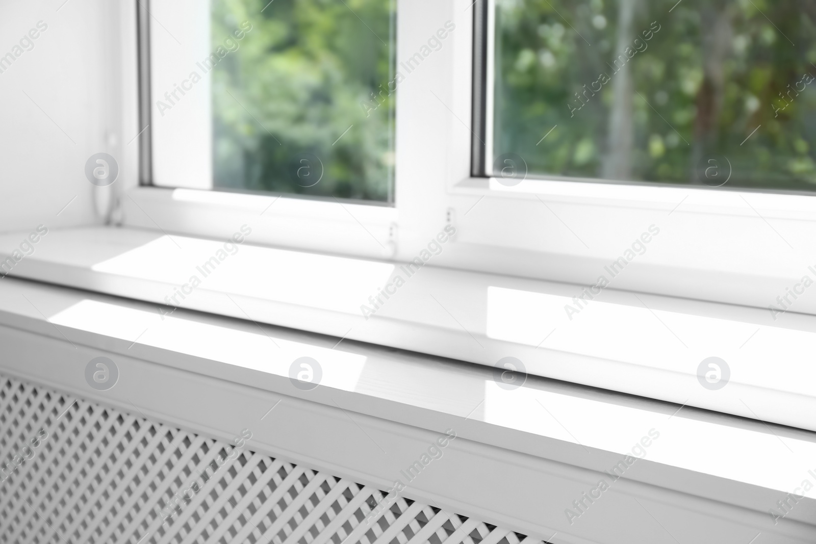 Photo of Closeup view of window with empty white sill