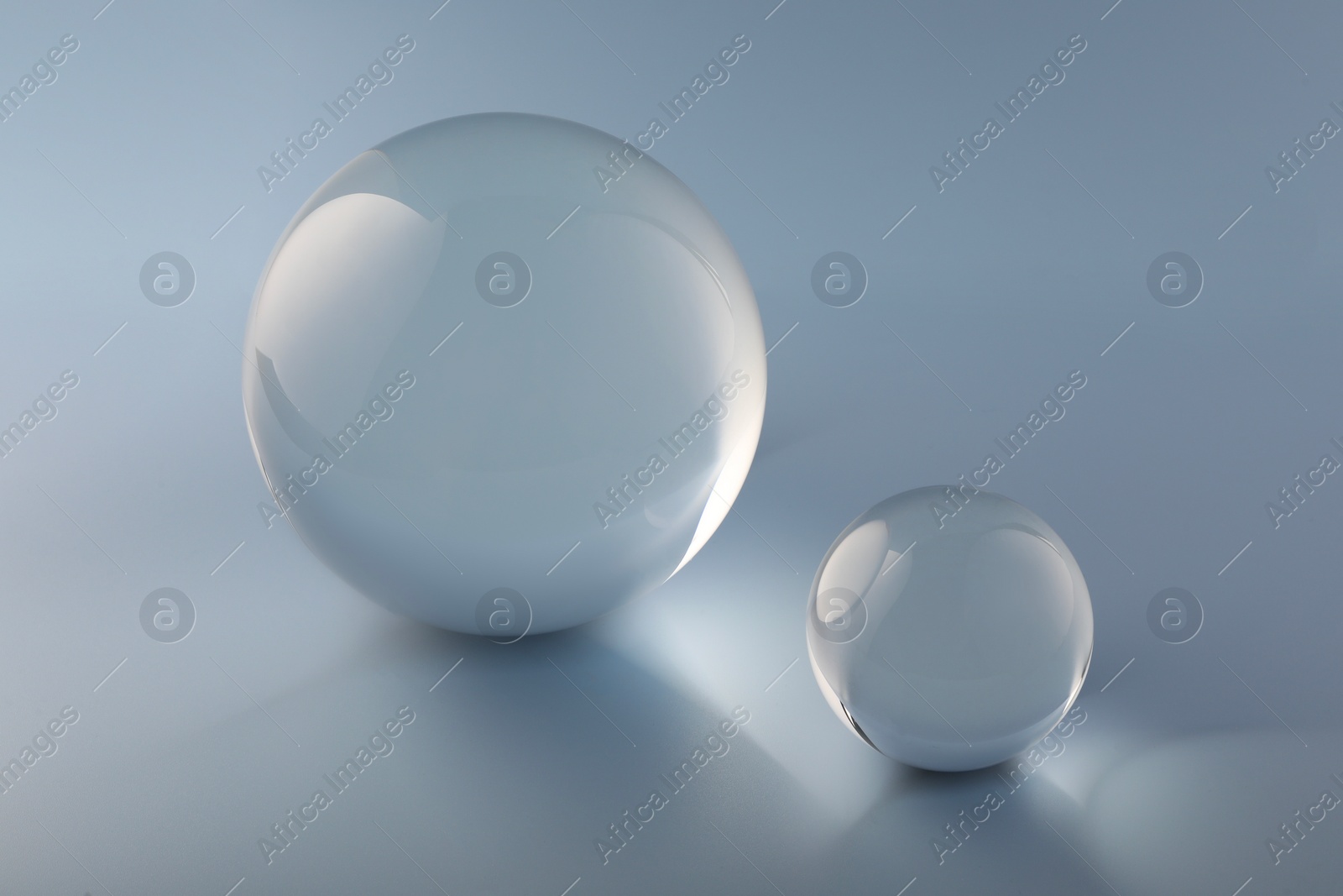 Photo of Transparent glass balls on light grey background