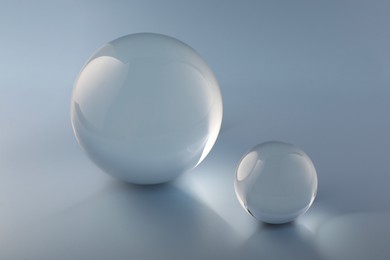 Photo of Transparent glass balls on light grey background