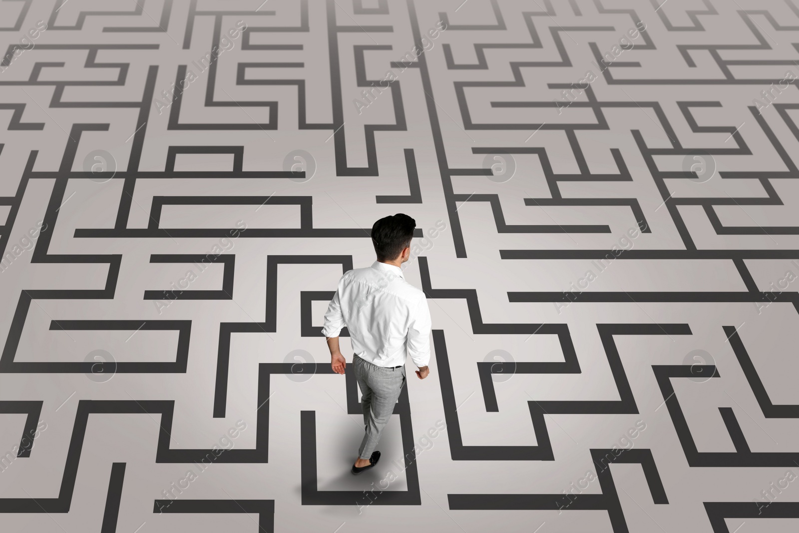 Image of Thoughtful businessman and illustration of maze on light background