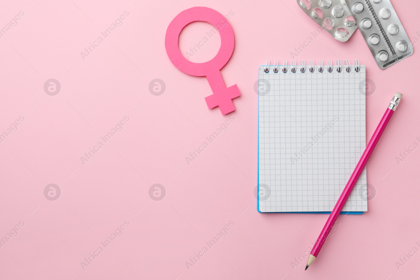 Photo of Flat lay composition with female gender sign and pills on pink background, space for text. Women's Health concept