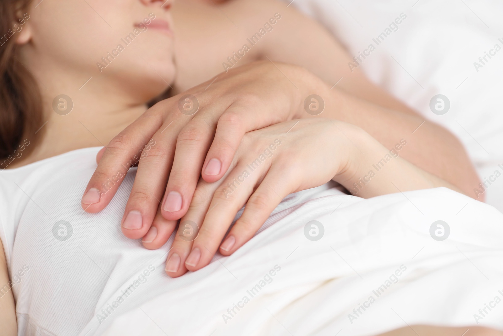 Photo of Lovely couple lying in bed, closeup view