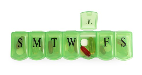 Different pills in organizer isolated on white, top view