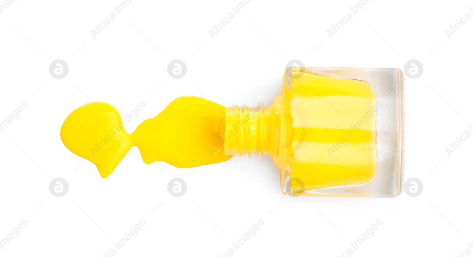 Photo of Overturned bottle of yellow nail polish isolated on white, top view