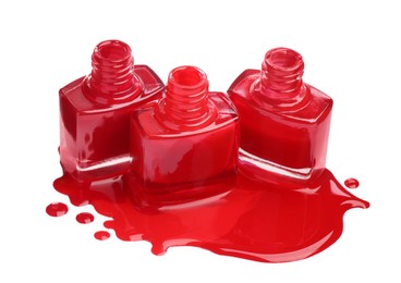 Puddle of red nail polish and bottles isolated on white