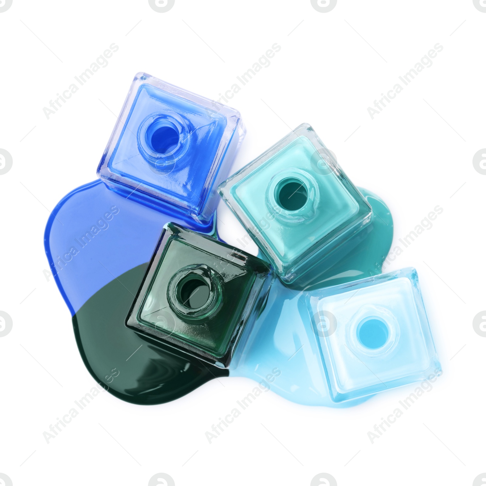 Photo of Puddle of different bright nail polishes and bottles isolated on white, top view