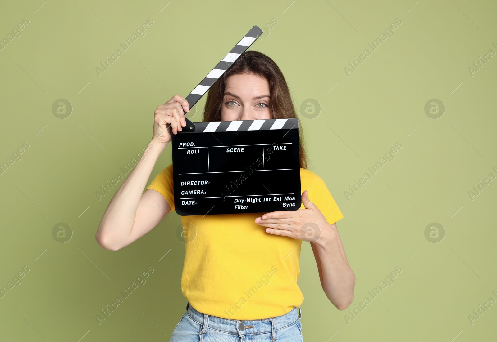 Photo of Making movie. Woman with clapperboard on green background