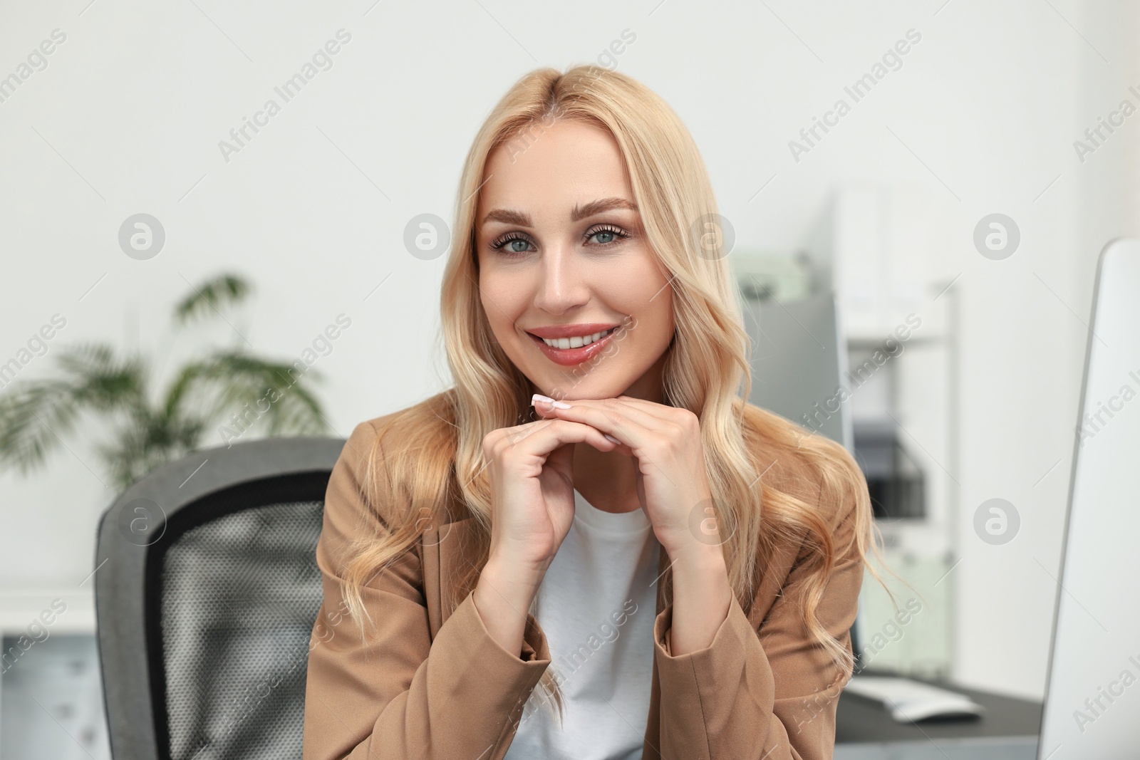 Photo of Portrait of happy beautiful secretary in office