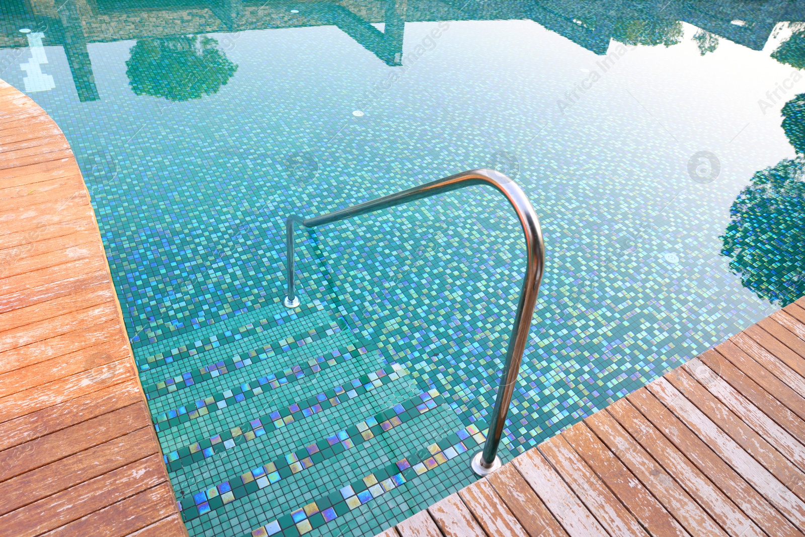 Photo of Outdoor swimming pool with steps and rail at resort