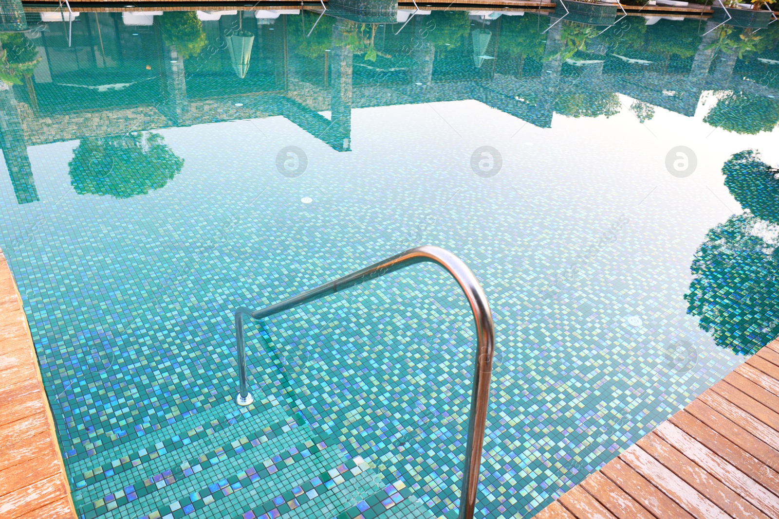 Photo of Outdoor swimming pool with steps and rail at resort