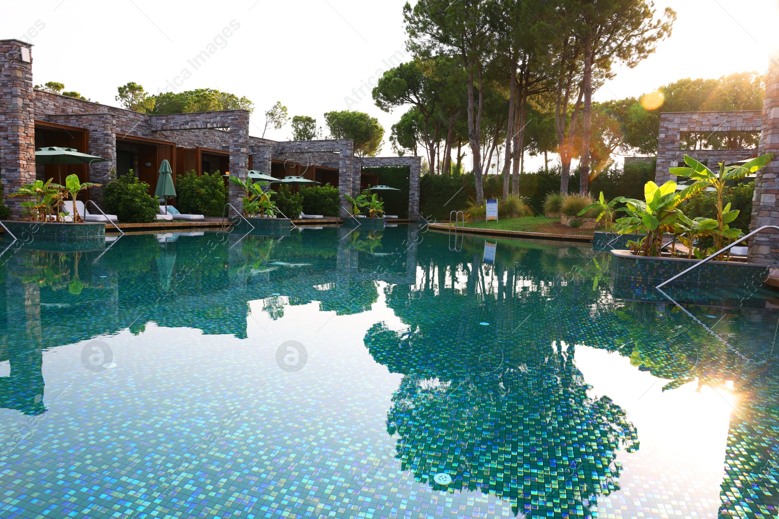 Photo of Outdoor swimming pool with umbrellas and sunbeds at resort