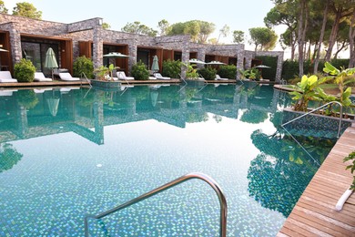 Outdoor swimming pool with wooden deck at resort