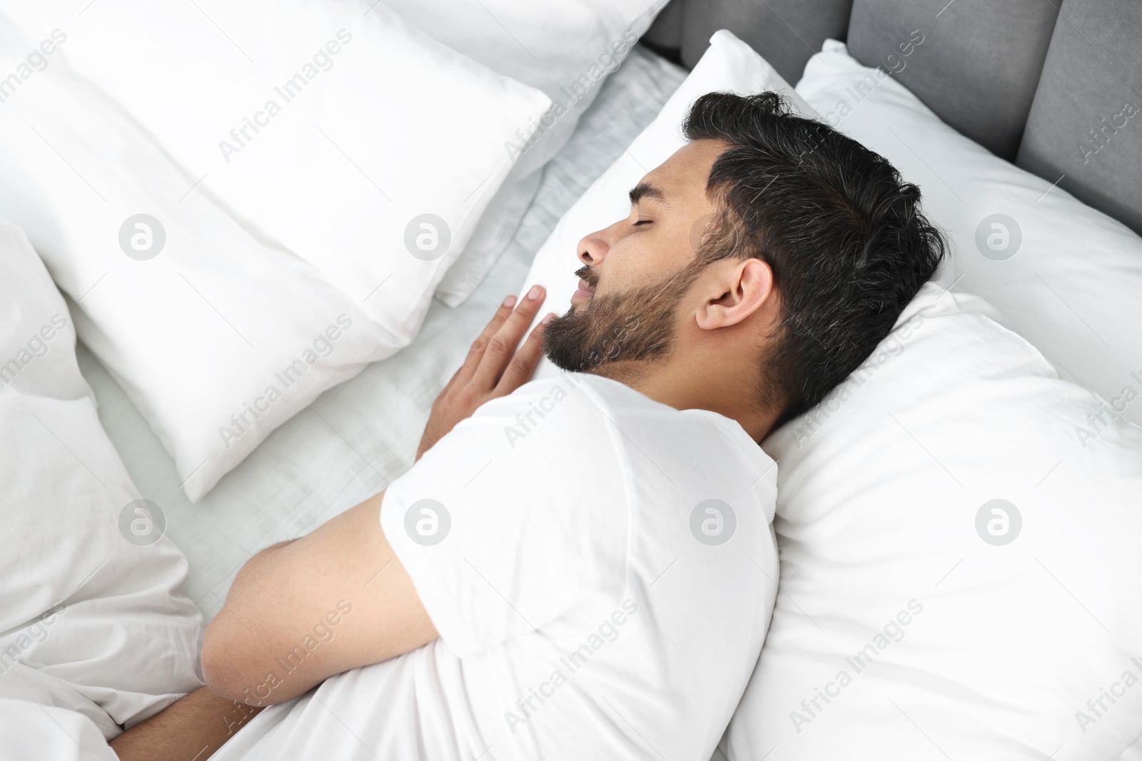 Photo of Handsome man sleeping on bed at morning