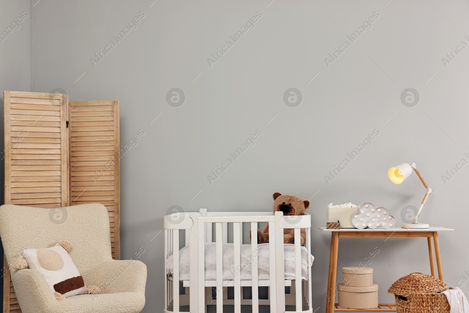 Photo of Newborn baby room interior with stylish furniture and comfortable crib