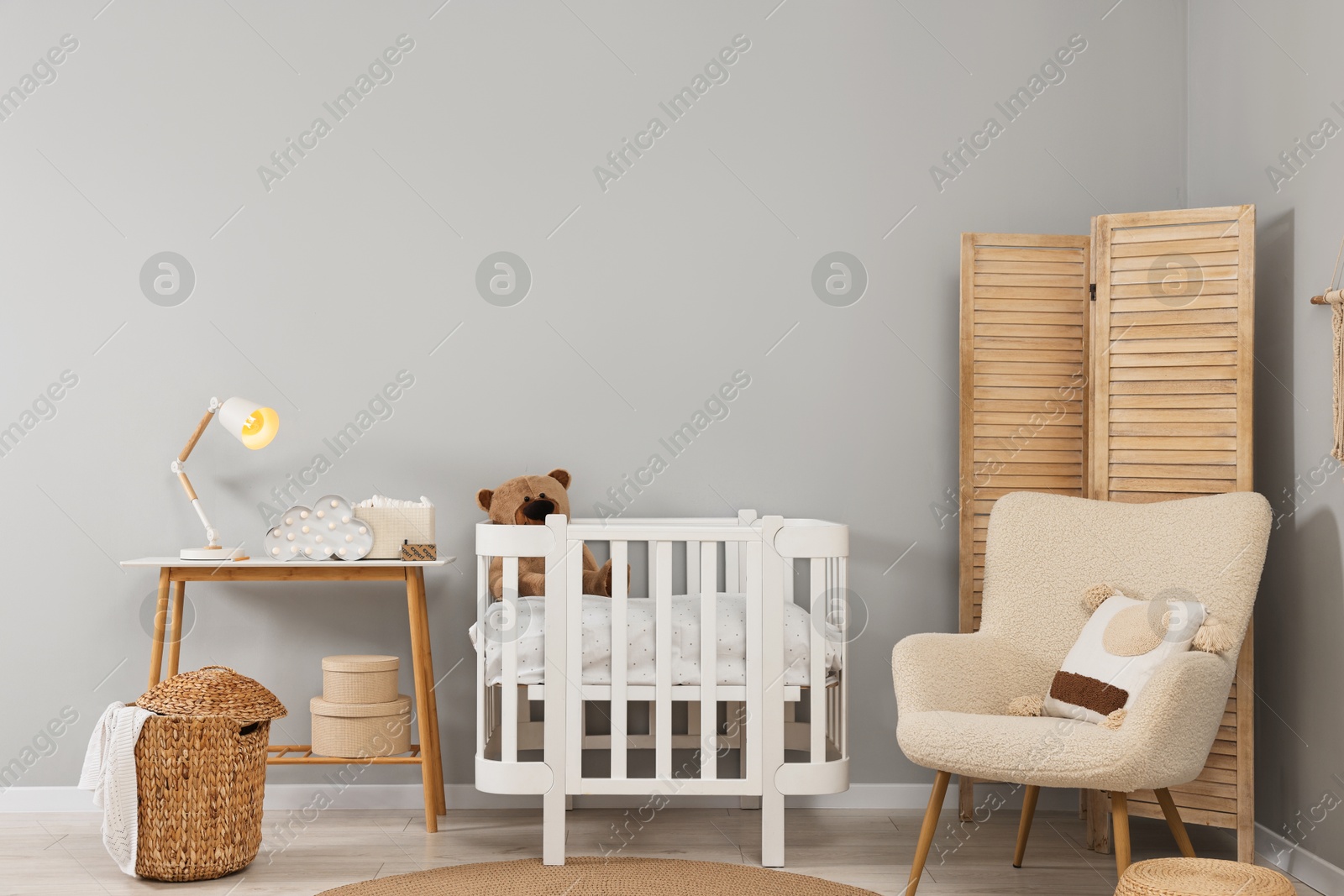 Photo of Newborn baby room interior with stylish furniture and comfortable crib