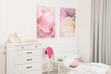 Cute child's room interior with modern furniture and beautiful pictures of on wall