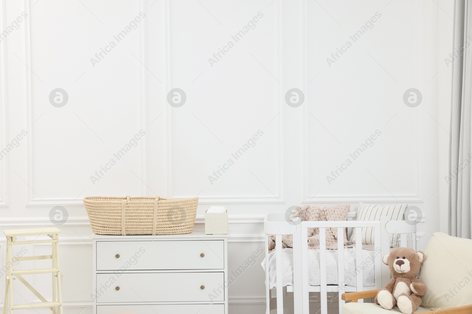 Photo of Newborn baby room interior with stylish furniture and comfortable crib