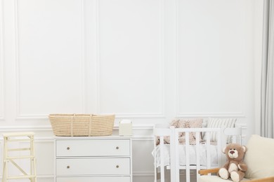 Newborn baby room interior with stylish furniture and comfortable crib