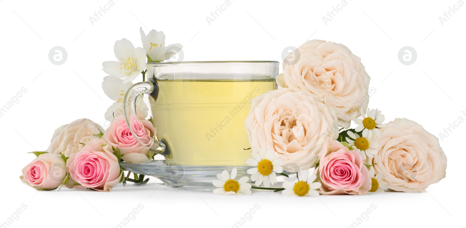 Photo of Aromatic herbal tea in glass cup and flowers isolated on white