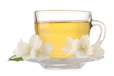 Aromatic herbal tea in glass cup and flowers isolated on white