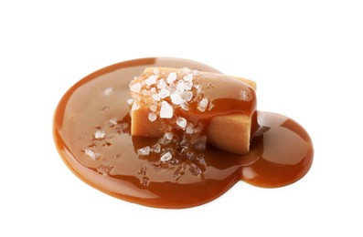 Photo of Yummy candy with caramel sauce and sea salt isolated on white