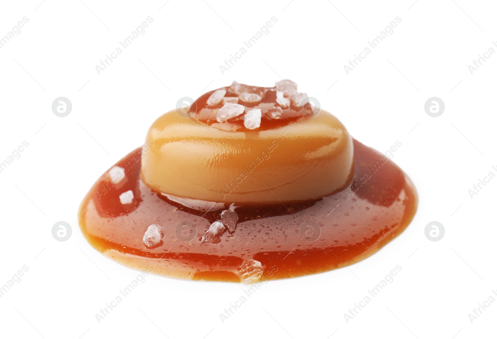 Photo of Yummy candy with caramel sauce and sea salt isolated on white