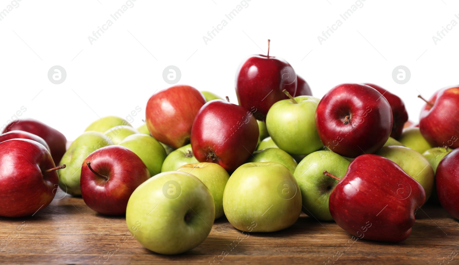 Photo of Fresh green and red apples on wooden table against white background