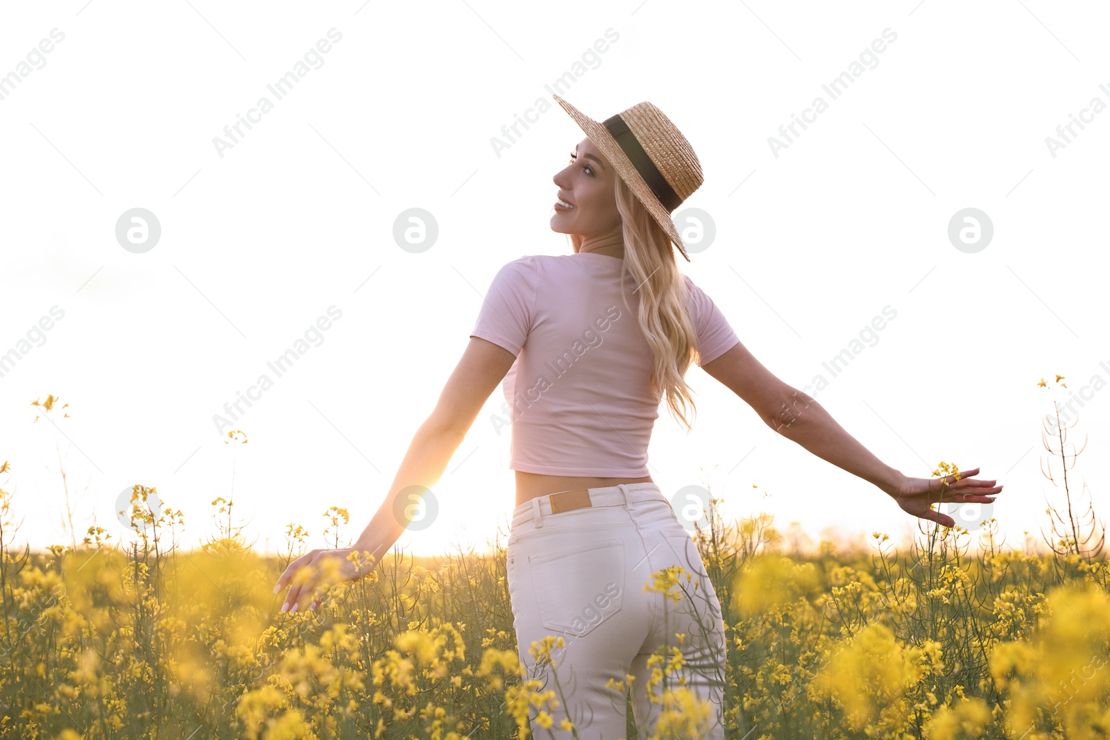 Photo of Portrait of happy young woman in field on spring day