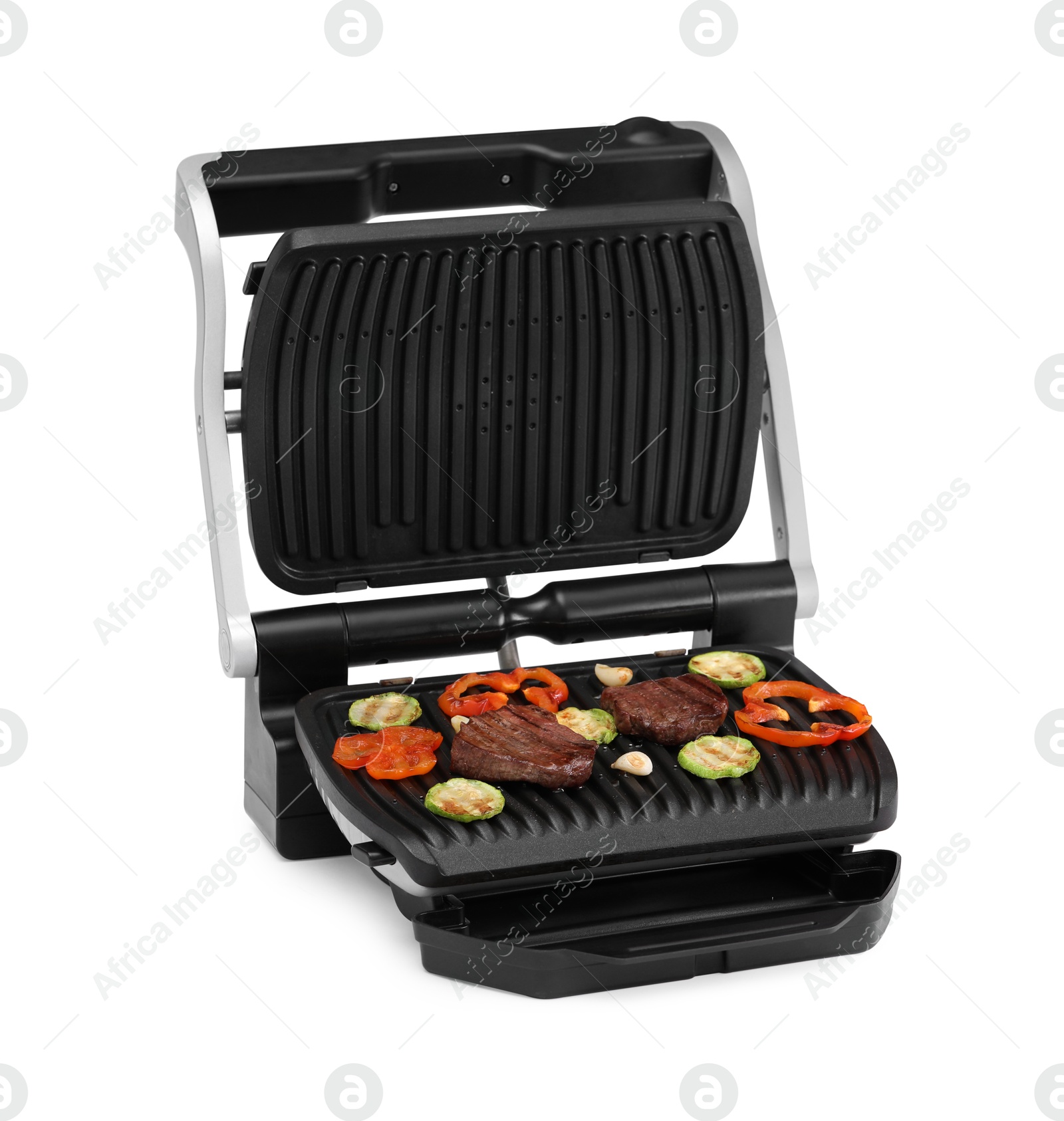 Photo of Electric grill with tasty meat and vegetables isolated on white