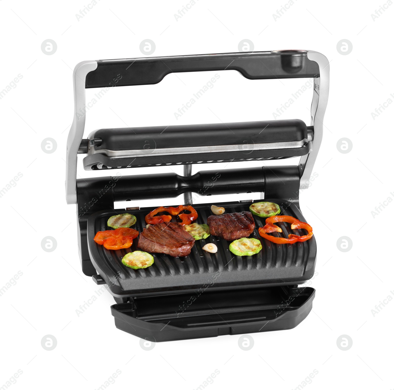 Photo of Electric grill with tasty meat and vegetables isolated on white