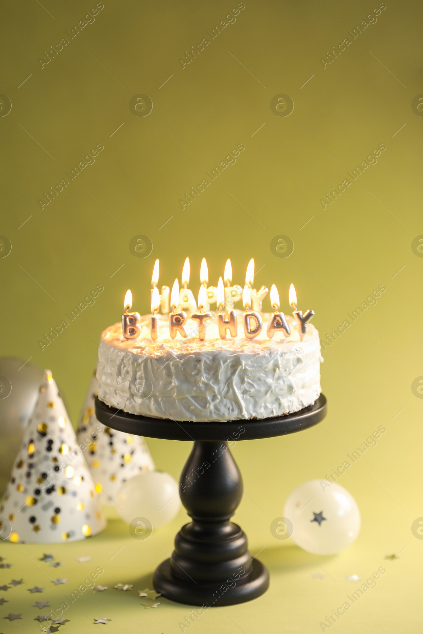 Photo of Tasty birthday cake with burning candles on green background