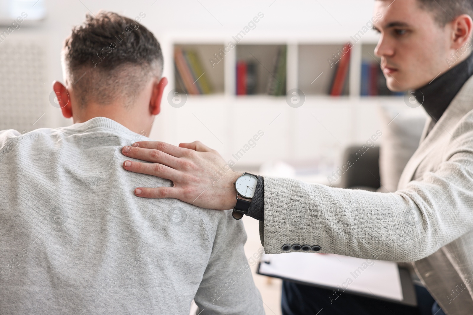 Photo of Professional psychotherapist working with patient in office, closeup