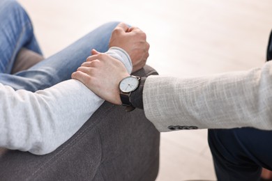 Photo of Professional psychotherapist working with patient indoors, closeup