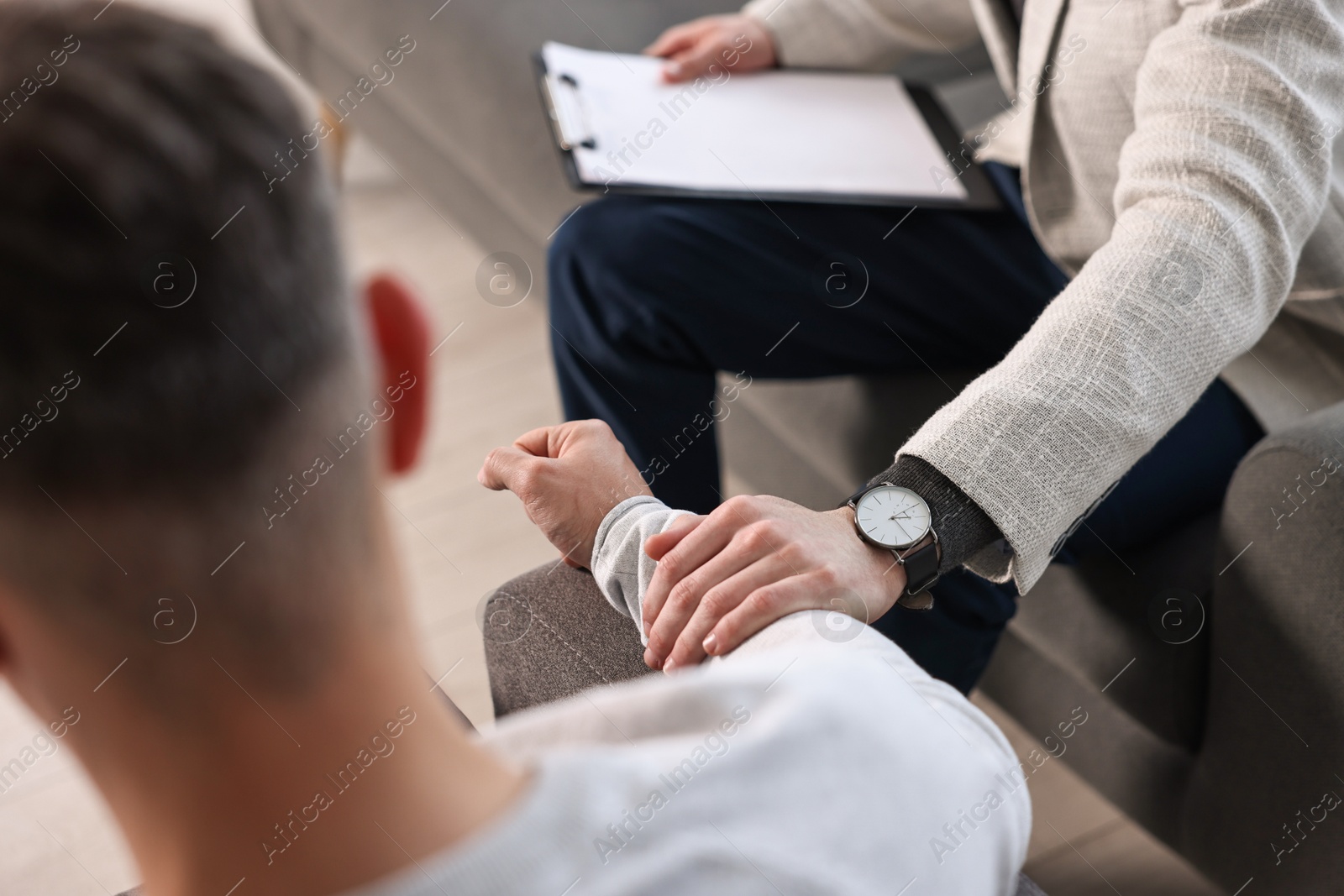 Photo of Professional psychotherapist working with patient in office, closeup