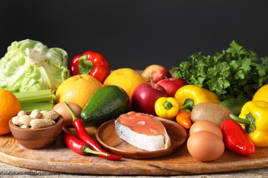 Photo of Healthy meal. Different vegetables and raw salmon on wooden table