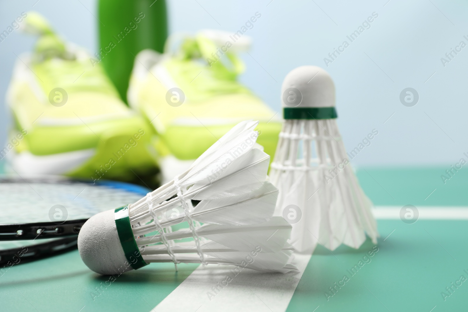 Photo of Two feather badminton shuttlecocks on court, closeup