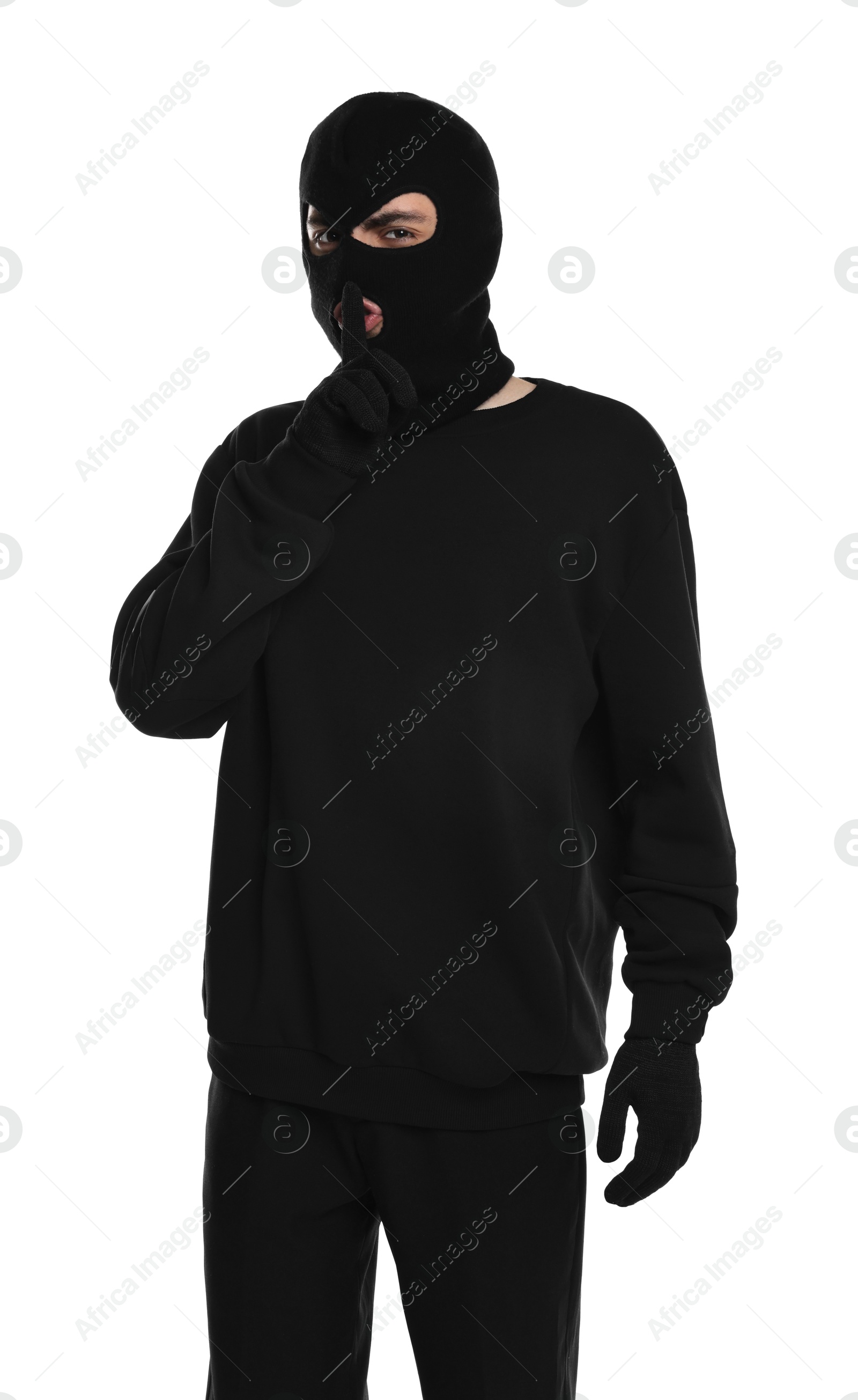 Photo of Thief in balaclava showing hush gesture on white background