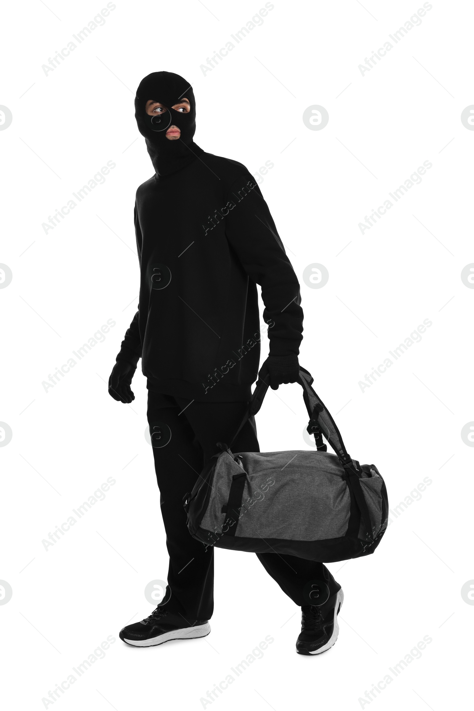 Photo of Thief in balaclava with bag on white background