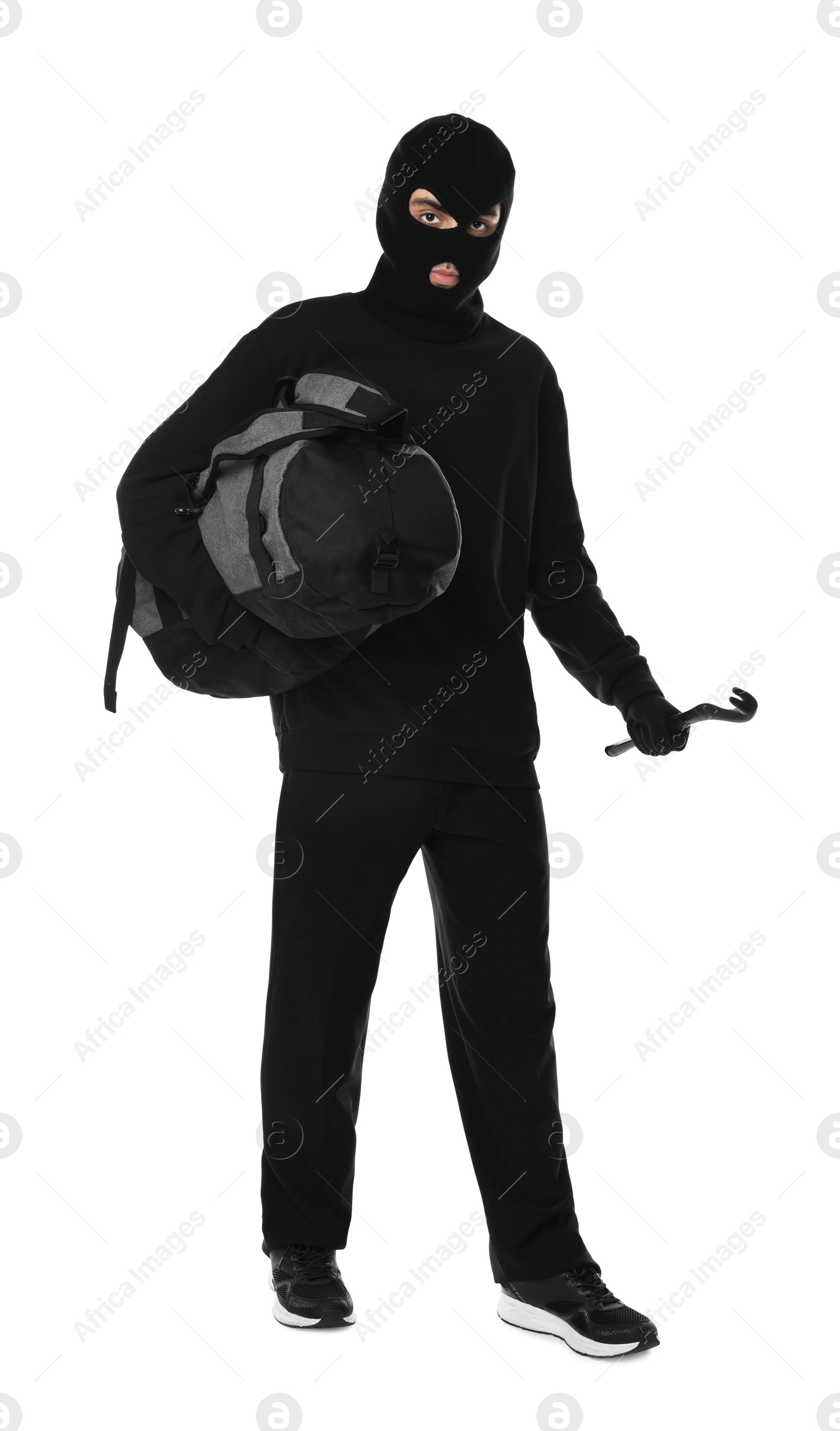 Photo of Thief in balaclava with crowbar and bag on white background