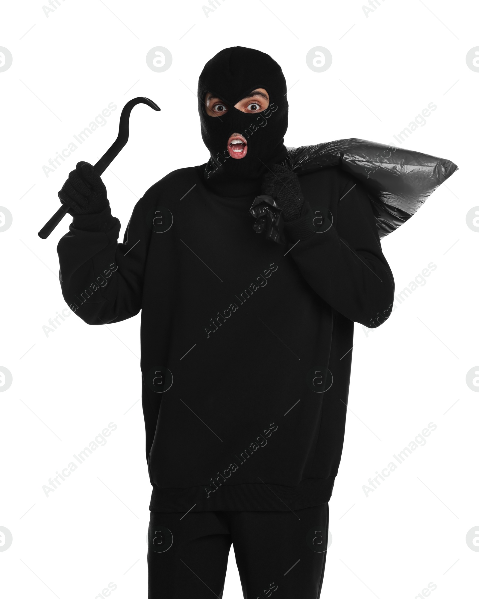 Photo of Emotional thief in balaclava with crowbar and bag on white background