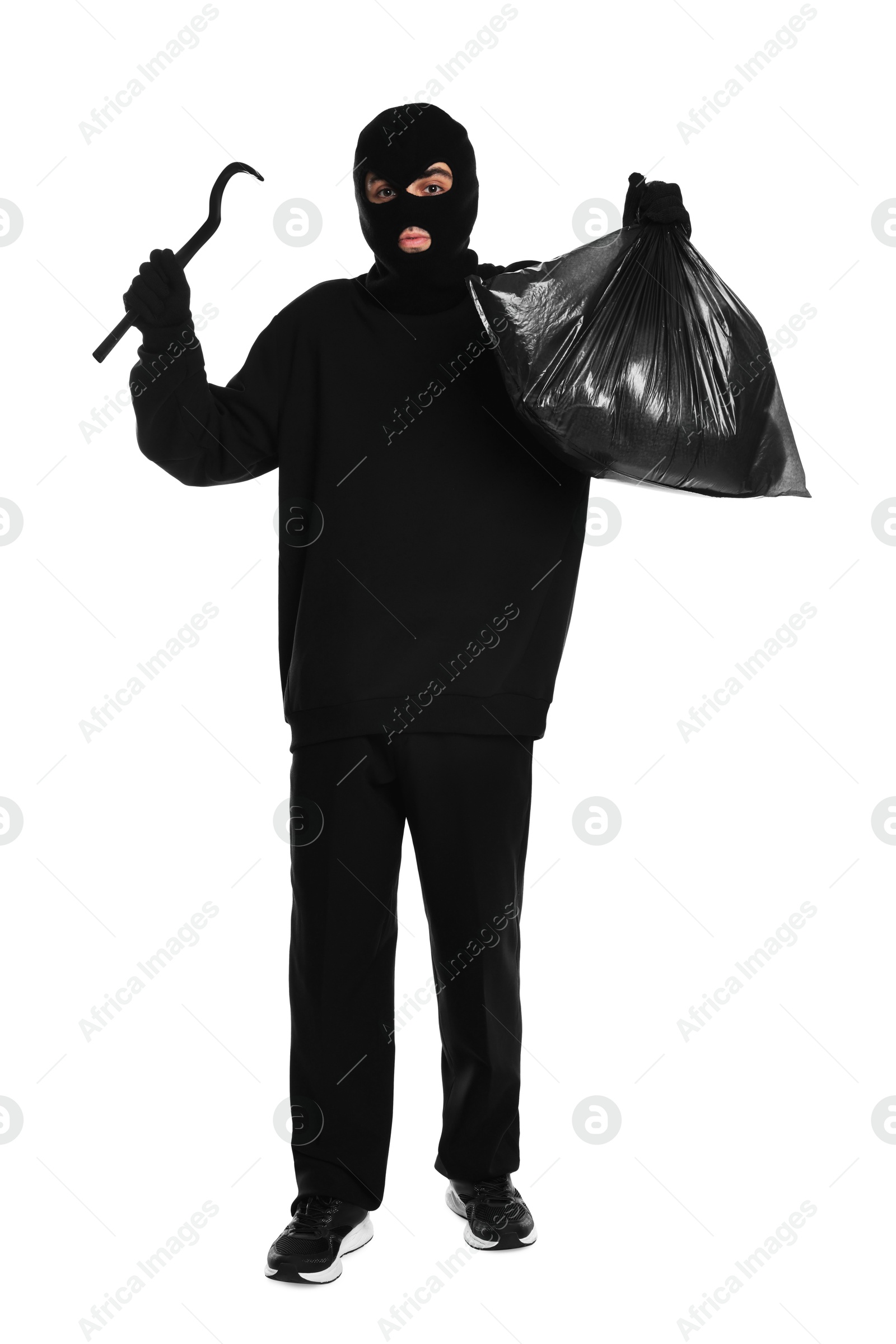 Photo of Thief in balaclava with crowbar and bag raising hands on white background