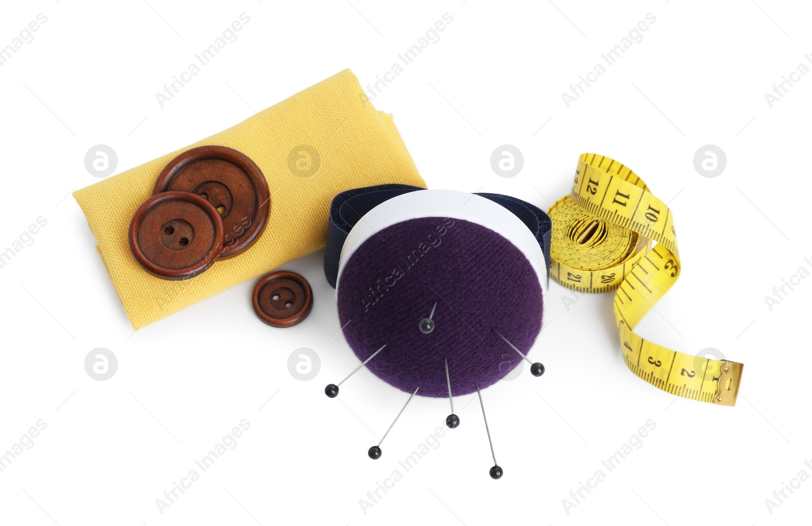 Photo of Pincushion, pins and other sewing tools isolated on white, above view