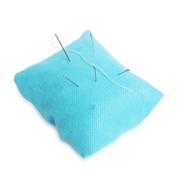 Photo of Light blue pincushion with sewing needles isolated on white