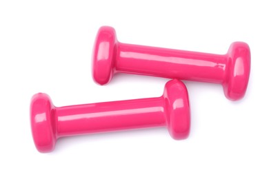 Pink dumbbells isolated on white, top view. Sports equipment
