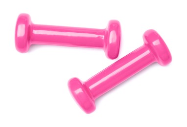 Pink dumbbells isolated on white, top view. Sports equipment