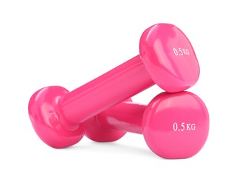 Photo of Pink dumbbells isolated on white. Sports equipment