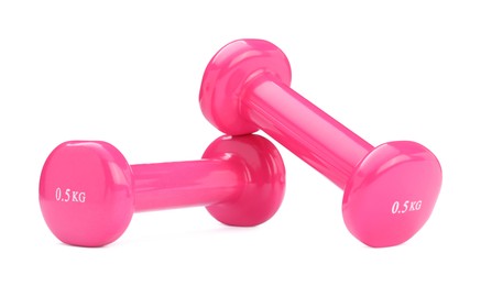 Photo of Pink dumbbells isolated on white. Sports equipment