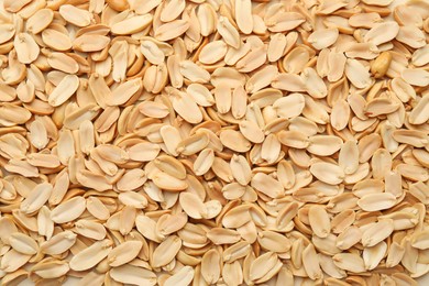 Photo of Fresh peeled peanuts as background, top view